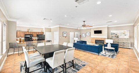 A spacious living room with a dining table and chairs.
